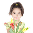 Beautiful little girl with a bouquet of tulips on white