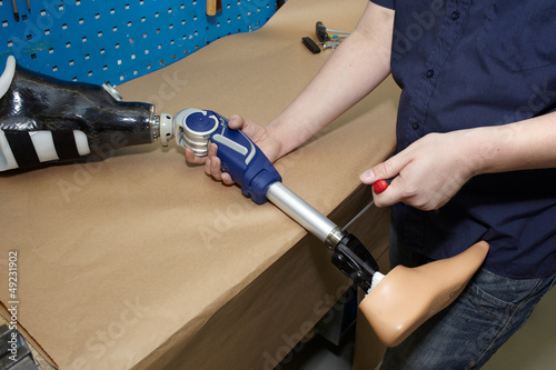 Photo: A technician adjusts a prosthetic foot. A technician adjusts a prosthetic foot.