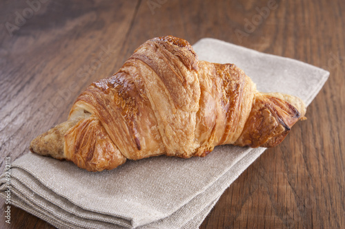 Photo: Butter croissant on rustic table Butter croissant on rustic table