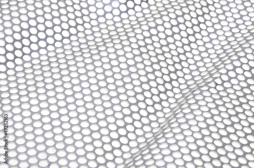 Photo: Shiny metal surface background with holes Shiny metal surface background with holes