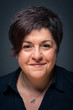 Photo: Middle age woman close up portrait on dark background. Middle age woman close up portrait on dark background.