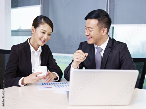 Photo: asian business people talking in office asian business people talking in office