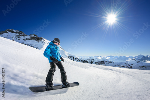 Photo: Snowboarder on piste in high mountains Snowboarder on piste in high mountains