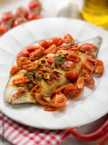 Photo: sole fish with tomato anchovy and hot chili pepper, selective fo sole fish with tomato anchovy and hot chili pepper, selective fo
