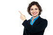 Photo: Smiling business professional pointing away Smiling business professional pointing away