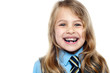 Photo: Face closeup of a cheerful young school girl Face closeup of a cheerful young school girl
