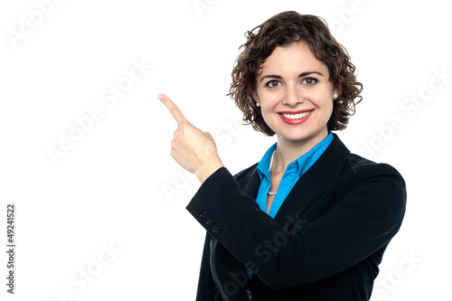 Photo: Smiling business professional pointing away Smiling business professional pointing away