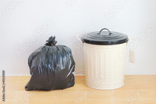Photo: a black plastic bag and reuse disposal bin a black plastic bag and reuse disposal bin