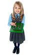 Photo: Pretty child in school uniform using calculator Pretty child in school uniform using calculator