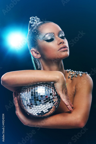 Photo: Woman with artistic make-up and discoball Woman with artistic make-up and discoball