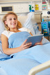 Photo: Teenage Female Patient In Hospital Bed With Digital Tablet Teenage Female Patient In Hospital Bed With Digital Tablet