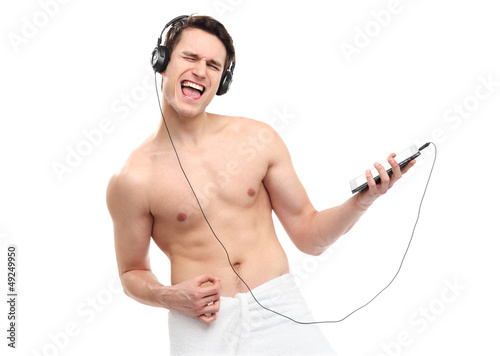 Photo: Man wrapped in towel listening to music Man wrapped in towel listening to music