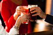 Young people holding cocktails in a pub