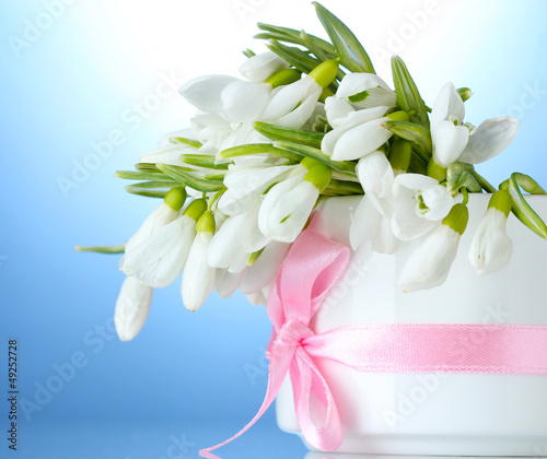 Photo: beautiful bouquet of snowdrops in vase with bow beautiful bouquet of snowdrops in vase with bow