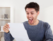 Exultant young man cheering good news