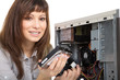 Photo: Frau als PC Techniker baut Festplatte ein Frau als PC Techniker baut Festplatte ein