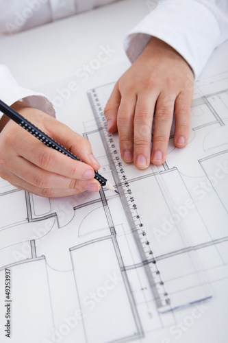 Photo: Architect working on blueprints Architect working on blueprints