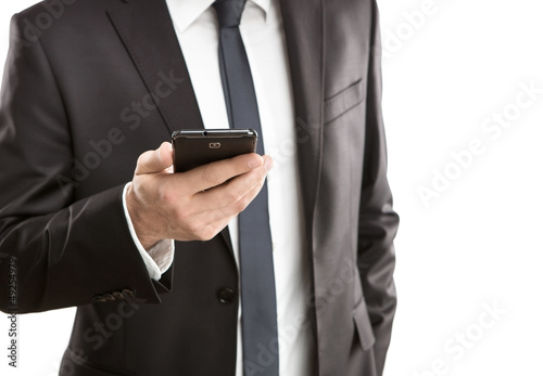Photo: Close up of young businessman using smart phone Close up of young businessman using smart phone