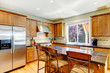Wood classic large kitchen with granite island.