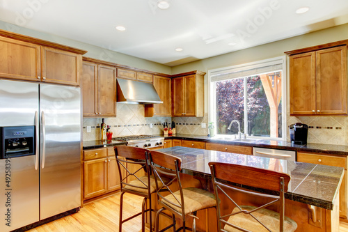 Photo: Wood classic large kitchen with granite island. Wood classic large kitchen with granite island.