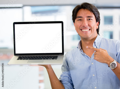 Photo: Businessman holding a computer Businessman holding a computer