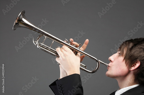 Photo: Portrait of a young man playing his Trumpet Portrait of a young man playing his Trumpet