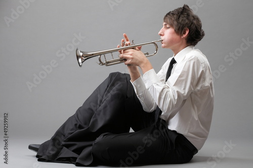 Photo: Portrait of a young man playing his Trumpet Portrait of a young man playing his Trumpet