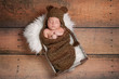 Sleeping Newborn Baby Boy Wearing a Bear Hat