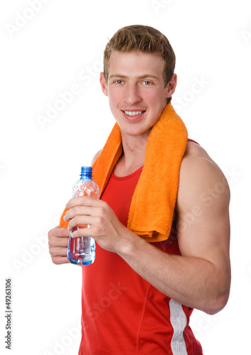 Photo: Young athletic man holding a bottle. isolated on white Young athletic man holding a bottle. isolated on white