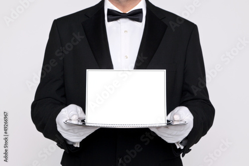 Photo: Butler holding a blank card upon a silver tray Butler holding a blank card upon a silver tray
