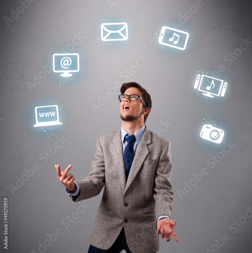 Photo: funny boy juggling with electronic devices icons funny boy juggling with electronic devices icons