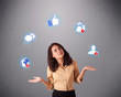 attractive young woman juggling with social network icons