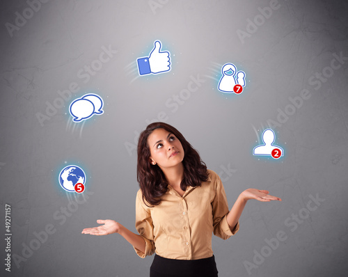 Photo: attractive young woman juggling with social network icons attractive young woman juggling with social network icons