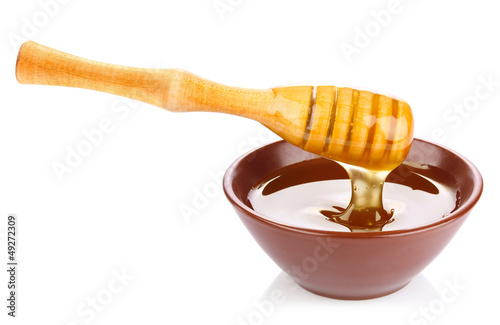 Photo: honey in pottery pan with dipper honey in pottery pan with dipper