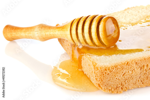 Photo: honey on bread slice with dipper honey on bread slice with dipper