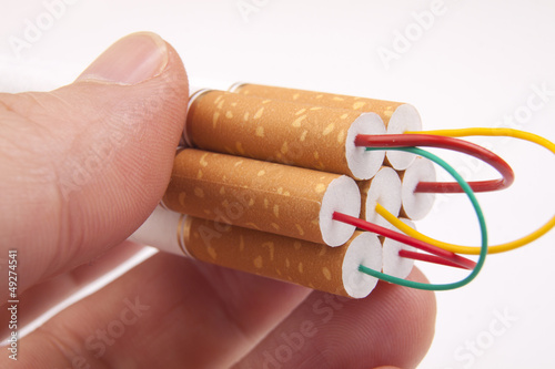 Photo: Hand holding stack of Cigarettes Hand holding stack of Cigarettes