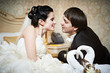 Handsome bride and groom in bedroom