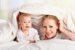 happy family. Mother and baby playing under  blanket