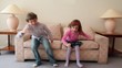 Video: Two kids boy with girl come in room, sit and jump on sofa Two kids boy with girl come in room, sit and jump on sofa