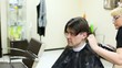 Video: Hairdresser cuts hair on nape to man with long hair by clipper Hairdresser cuts hair on nape to man with long hair by clipper