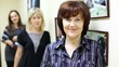 woman working in beauty salon affably looks and smiles against