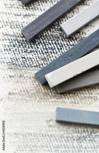 Photo: Close up of gray hard pastels Close up of gray hard pastels