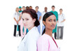 Serious doctor and nurse standing back to back