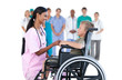 Nurse chatting with little boy in wheelchair