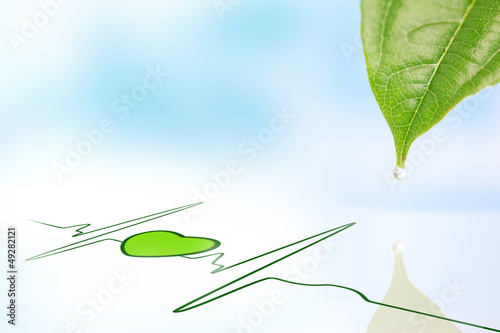 Photo: Dew drop falling from leaf onto green ECG line with heart symbol Dew drop falling from leaf onto green ECG line with heart symbol