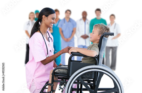 Photo: Nurse chatting with little boy in wheelchair Nurse chatting with little boy in wheelchair