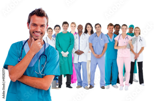 Photo: Happy surgeon with medical staff behind him Happy surgeon with medical staff behind him