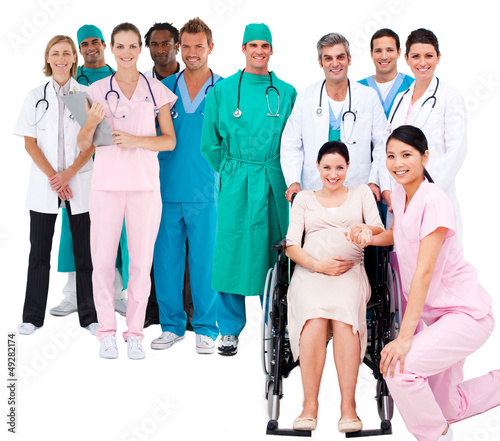 Photo: Nurse with pregnant woman in wheelchair with medical staff Nurse with pregnant woman in wheelchair with medical staff