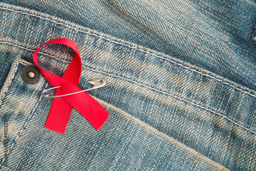 Photo: Aids awareness ribbon pinned on to jeans Aids awareness ribbon pinned on to jeans