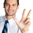 Businessman showing three fingers, isolated